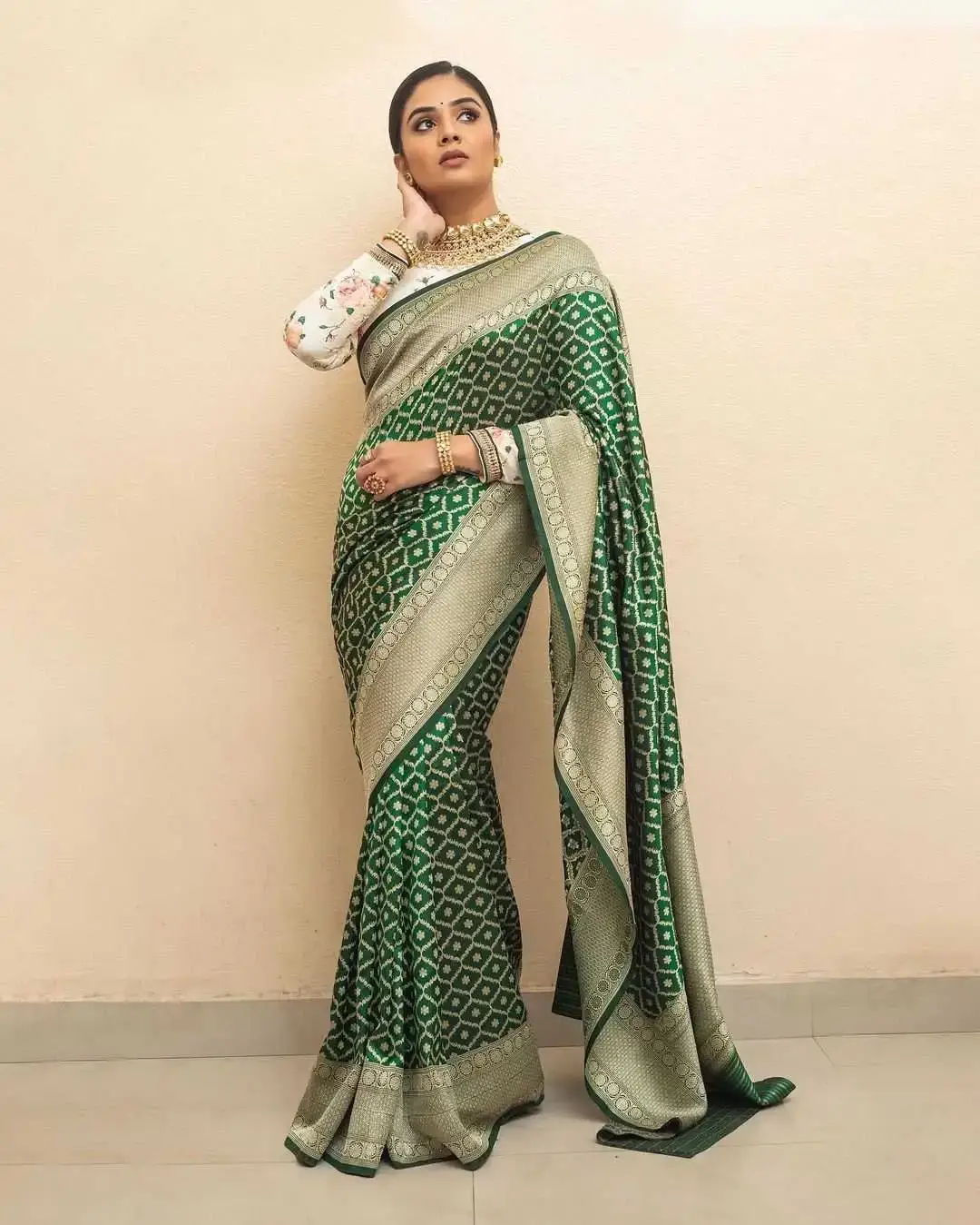 Indian TV Model Sreemukhi in a green Banarasi saree